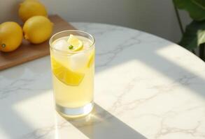 A glass of lemonade on a table with lemons photo