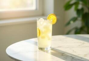 A lemonade drink with ice and a slice of lemon on top photo