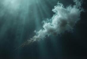 A cloud is floating in the ocean with rays of light coming from it photo