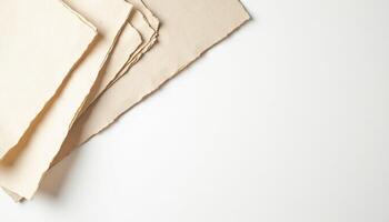 A pile of old paper on a white surface photo