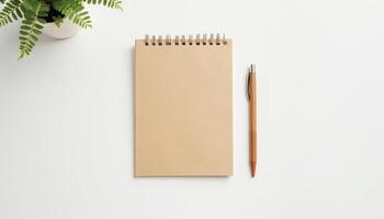 Notebook with pen and fern on white background photo