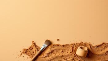 Creamy beige foundation powder with brush on smooth background for makeup photo