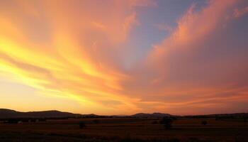Sunset sky with orange clouds over dark mountain silhouette and field landscape photo