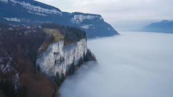 Alpine Cliff Overlooking a Sea of Fog A Winters Dreamscape photo