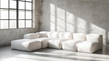 Minimalist White Modular Sofa in Bright Industrial Loft With Sunlight and Textured Walls photo