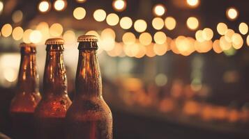 Chilled Beverages Three Brown Bottles in a Row Lit by String Lights photo