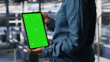 Data center worker using green screen mockup tablet, doing maintenance on rigs handling AI tasks. Server hub admin using chroma key device to manage storage arrays supporting deep learning, camera B video