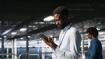 Data center engineer doing maintenance tasks on systems to ensure optimal performance. IT professional reviewing diagnostics and applying patches to server hub improve stability, camera B video