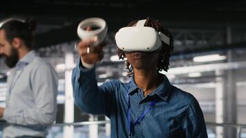 Data center programmer using virtual reality technology to simulate artificial intelligence neural networks. Woman in server farm using VR headset equipment to oversee AI systems, camera B video