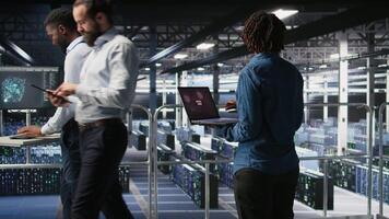 Data center software developer panicking after receiving critical error popup on laptop display. African american woman in server hub alerted by bugs causing low hardware performance, camera A video