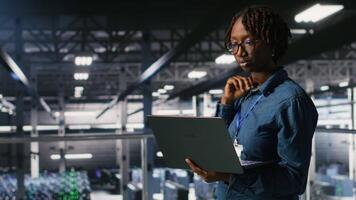 Data center teamworking colleagues running diagnostics on equipment to identify errors, doing brainstorming. Engineering team preventing rigs failure to minimize downtime, camera B video