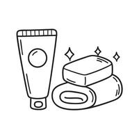A toothpaste tube near a bar of soap and towel vector