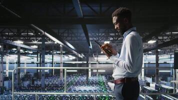 Data center engineer doing maintenance tasks on systems to ensure optimal performance. IT professional reviewing diagnostics and applying patches to server hub improve stability, camera A video