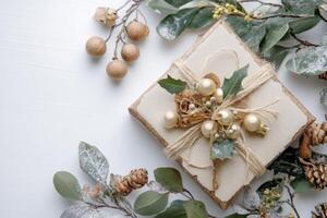 a gift wrapped in white paper with gold balls photo