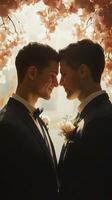 two men in suits are standing under a cherry blossom tree photo