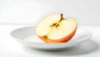 Sliced red apple on white plate photo
