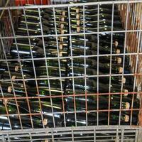 Bottles of sparkling wine in a metal box at a winery. photo