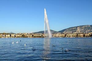 The Jet d'Eau fountain in Geneva overlooking the lake and mountains. photo