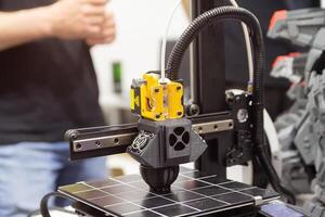 Modern 3D printer printing plastic product photo