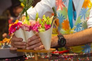 Hands of a man which in a beautiful bouquet of flowers photo