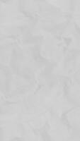 Stop motion looping animated crumpled white paper texture background video