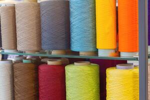 Multi-colored threads at the exhibition stand. Industry photo