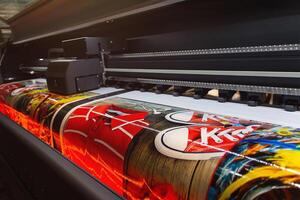 Large format printing machine in operation close-up. Media photo
