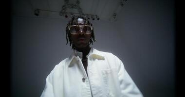 A stylish man raps while looking at the camera. Filming a music in the studio photo