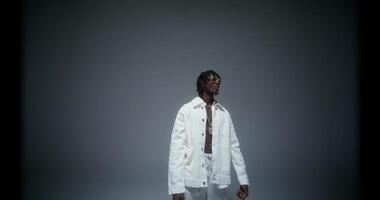 A man is dancing and singing in the studio. He looks at the camera with serious look. Recording the rapper's music photo