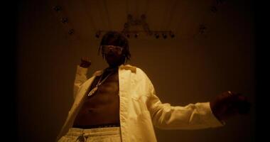An man is dancing in the studio by the light of flashes. photo