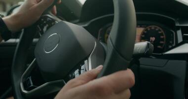 A man drives a car. Close-up of his hands, an unrecognizable person. View from the car interior. Summer photo