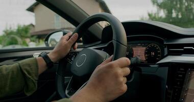 A man drives a car. Close-up of his hands on the steering wheel, an unrecognizable person. View from the car interior. photo