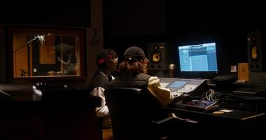 Collaboration in a recording studio. Listening to a song after recording photo