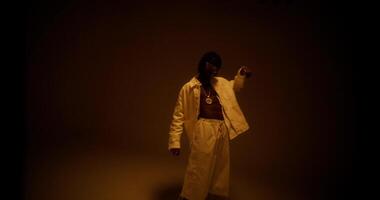 An African-American man is dancing in the studio by the light photo