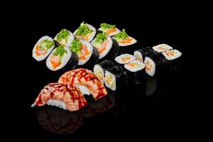 Sushi set with salmon, avocado and cucumber filling on black background photo