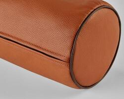 Close-up of cylindrical leather object showing stitching and texture photo