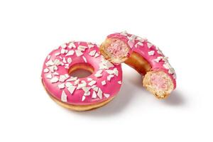 Two pink glazed donuts with white sprinkles, one broken in half showing filling photo