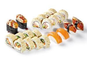 Sushi set with salmon nigiri, sesame rolls, fried eel rolls and gunkan maki on white background photo