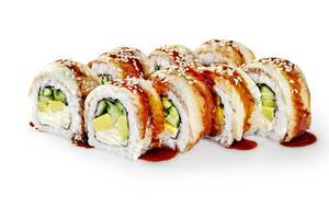 Delicious sushi rolls with eel, avocado, cucumber, cream cheese, sesame and unagi sauce on white background photo