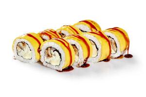 Close-up of uramaki sushi rolls with cheese, fish and teriyaki sauce on white background photo