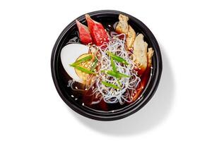 Steaming chicken and shirataki noodle soup with egg and sesame seeds photo