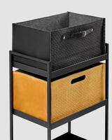 Modern shelving unit displaying stylish storage baskets with leather and woven details photo