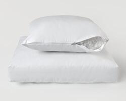 White pillow with open zipper revealing filling material resting on another pillow photo