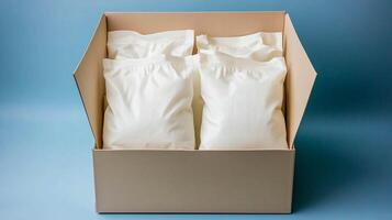 Packaged white bags arranged neatly in a cardboard box against a soft blue background photo