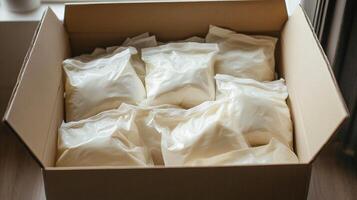 Packaged food items stored in a cardboard box for distribution at a local community center photo