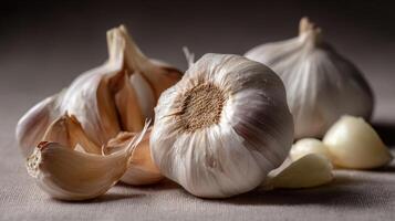 Macro shot showcasing peeled garlic cloves with whole bulbs on a textured surface in soft lighting photo