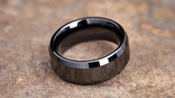 Polished zirconium ceramic ring displayed on rustic stone surface showcasing elegant design photo