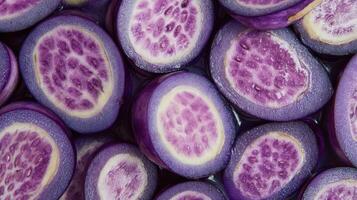 Close up of glossy purple eggplant slices showing vibrant inner texture and color photo