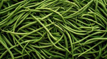 Dense arrangement of fresh green beans showcasing their long shape and vibrant color in a market setting photo
