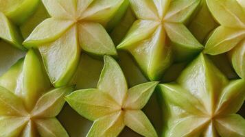 Close up view of freshly cut star fruit carambola slices creating a vibrant display on the table photo